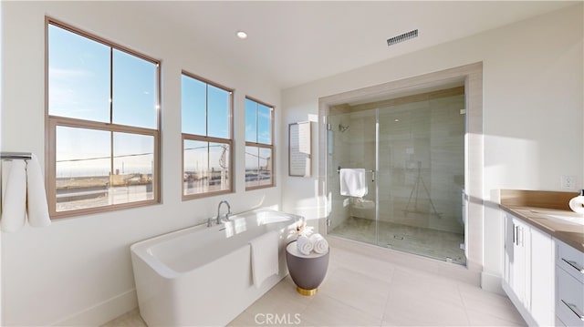 bathroom featuring tile patterned floors, vanity, and independent shower and bath