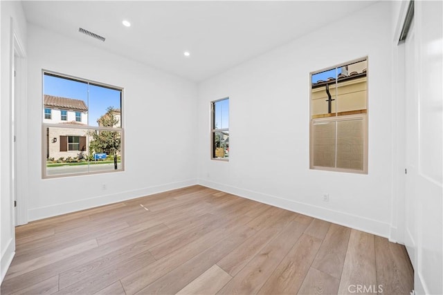 unfurnished room featuring light hardwood / wood-style floors