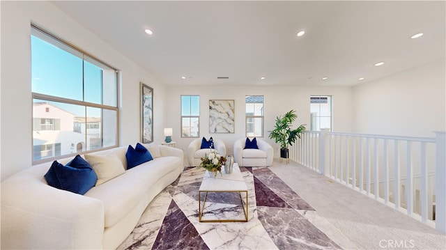 living room with plenty of natural light and light colored carpet