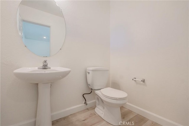 bathroom featuring toilet and hardwood / wood-style flooring