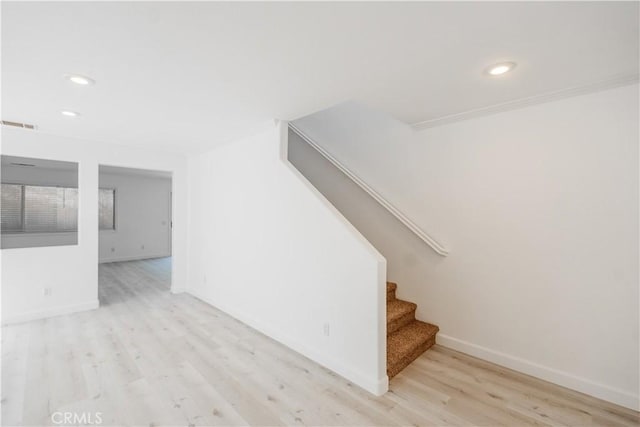 stairway with hardwood / wood-style flooring