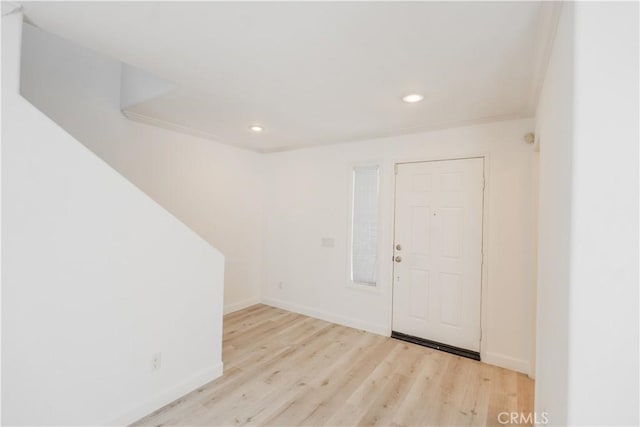 entrance foyer with light hardwood / wood-style flooring and ornamental molding