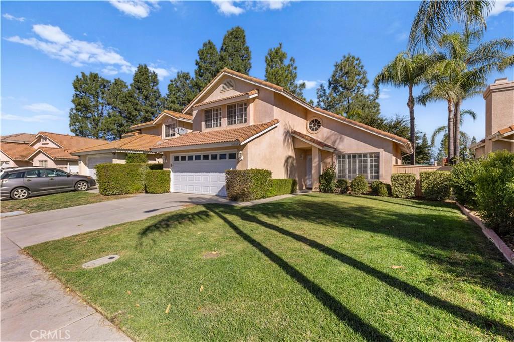 view of front of property with a front yard and a garage