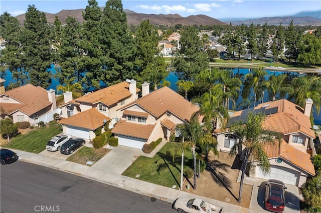 drone / aerial view featuring a water and mountain view