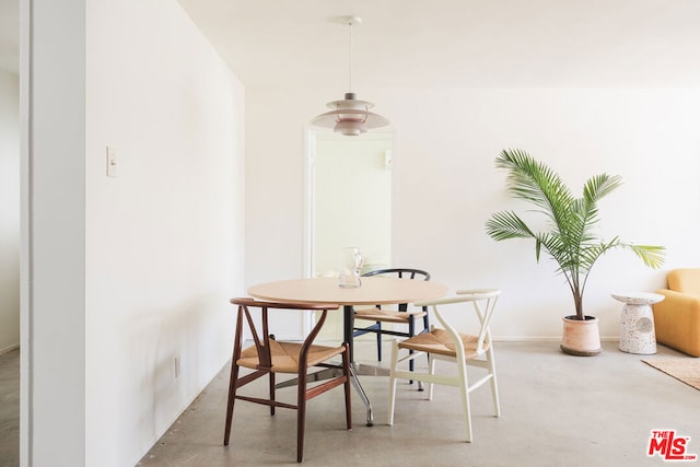 dining room featuring concrete flooring