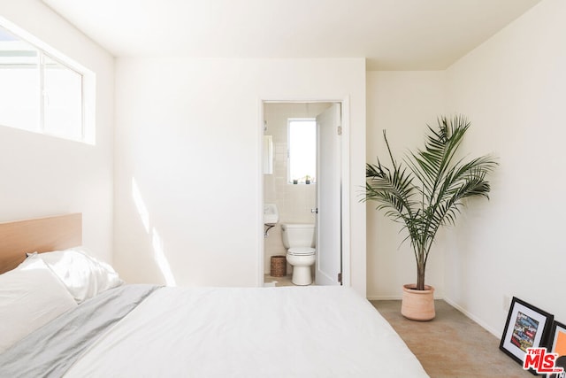 carpeted bedroom featuring connected bathroom