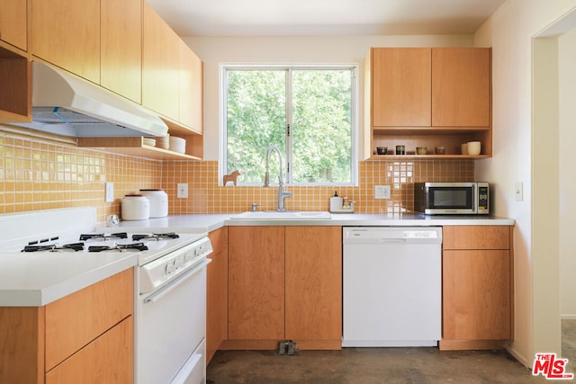 kitchen with decorative backsplash, sink, and white appliances