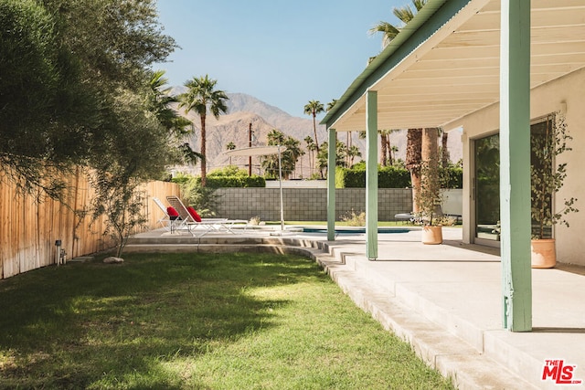 view of yard featuring a patio area and a mountain view