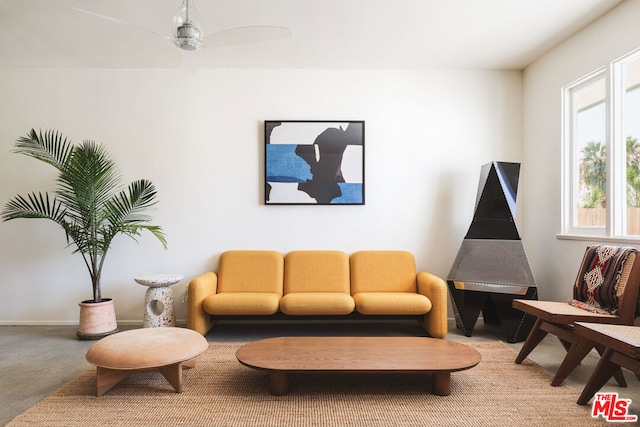 living room featuring carpet and ceiling fan