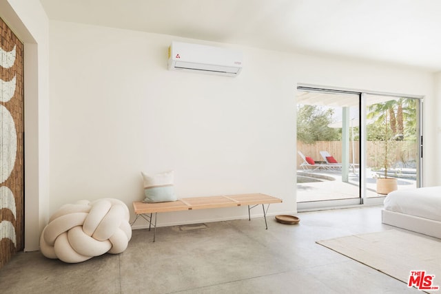 doorway with a wall mounted air conditioner and concrete flooring