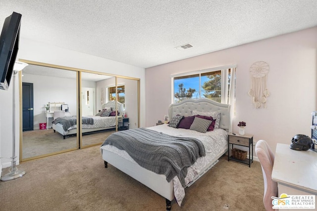 bedroom featuring a closet, a textured ceiling, and light colored carpet