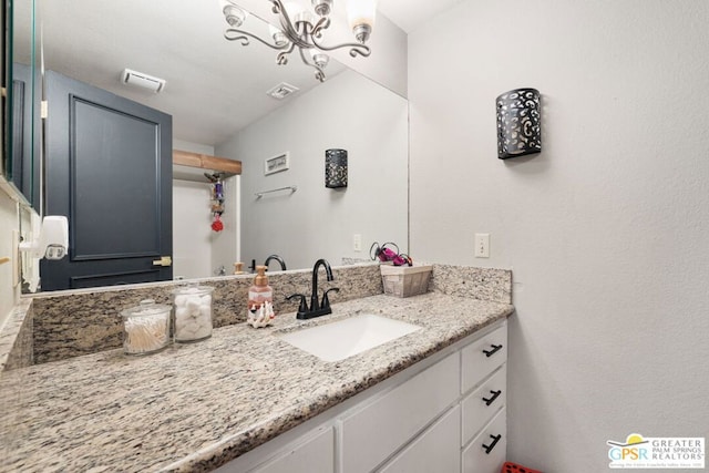 bathroom with vanity and a chandelier