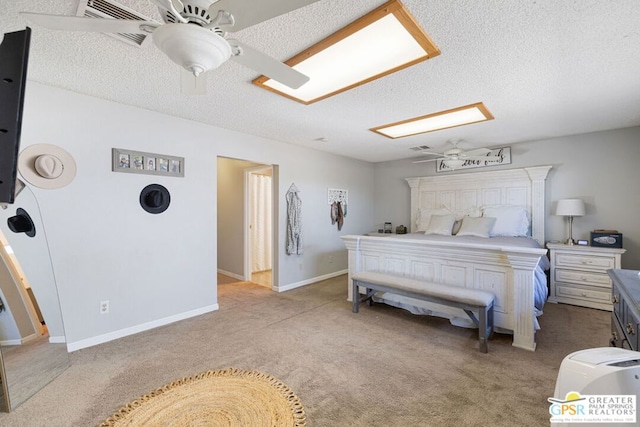 carpeted bedroom with a textured ceiling and ceiling fan