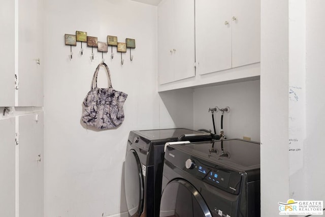 laundry area featuring cabinets and washing machine and clothes dryer