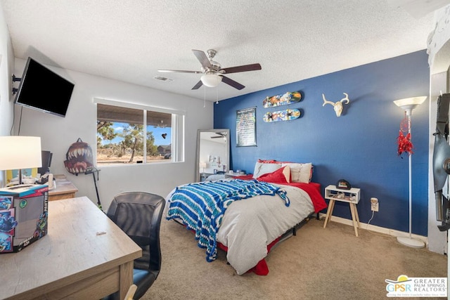 carpeted bedroom featuring a textured ceiling and ceiling fan