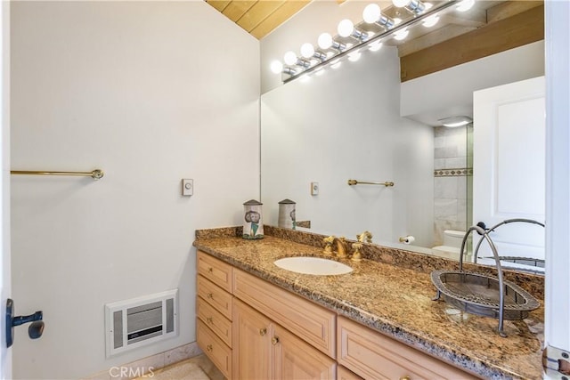 bathroom with vanity and toilet