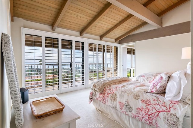 carpeted bedroom with vaulted ceiling with beams, wood ceiling, multiple windows, and access to outside