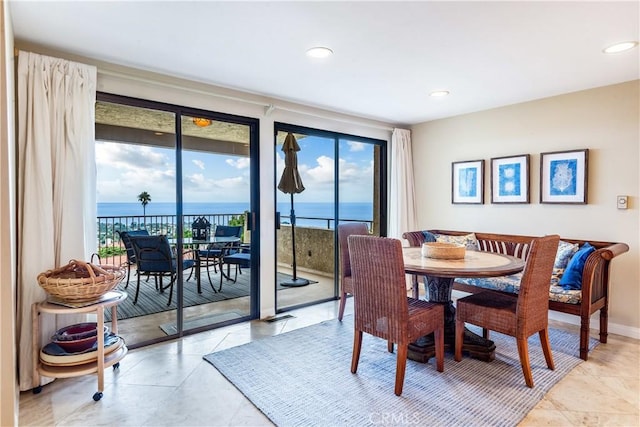 dining room with a healthy amount of sunlight and a water view