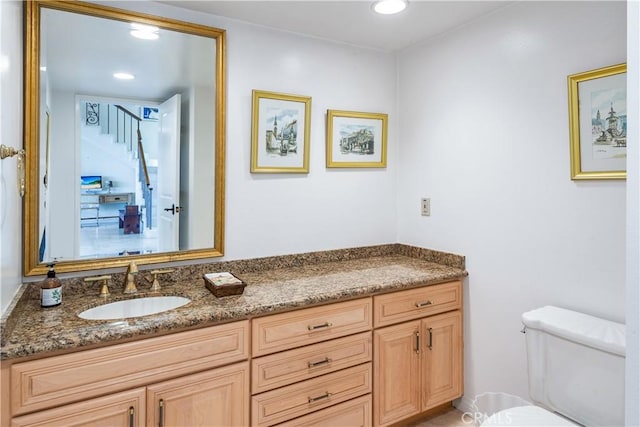 bathroom with vanity and toilet