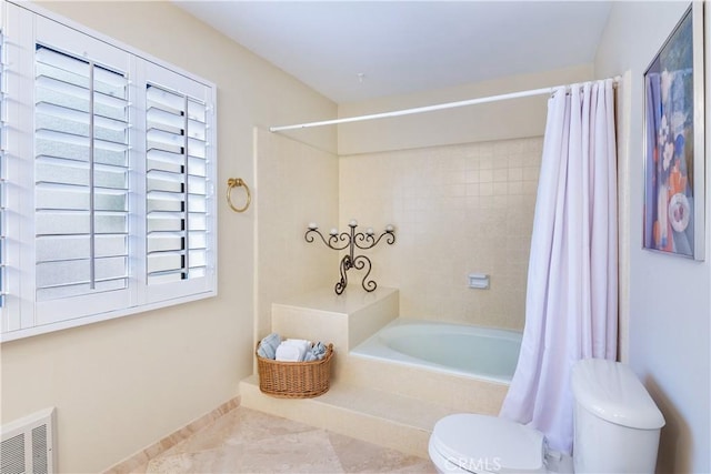 bathroom with shower / bath combo and toilet