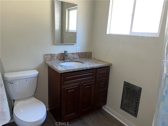 bathroom featuring vanity, toilet, and hardwood / wood-style flooring