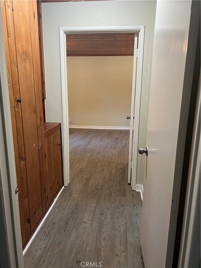 hallway with dark hardwood / wood-style floors