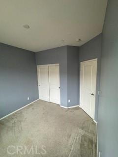 unfurnished bedroom with carpet and a closet