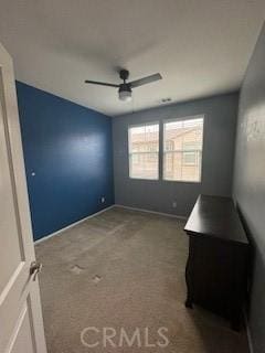 empty room featuring carpet flooring and ceiling fan