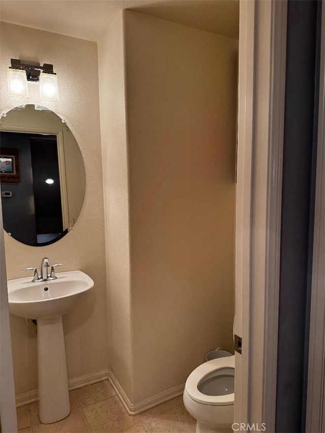 bathroom with toilet and tile patterned floors