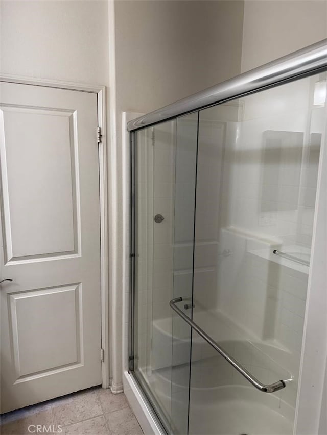 bathroom featuring tile patterned floors and an enclosed shower