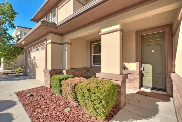 view of exterior entry with a garage