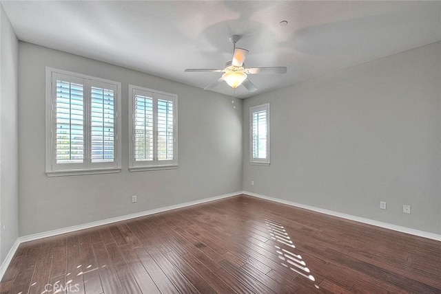 unfurnished room with ceiling fan and dark wood-type flooring