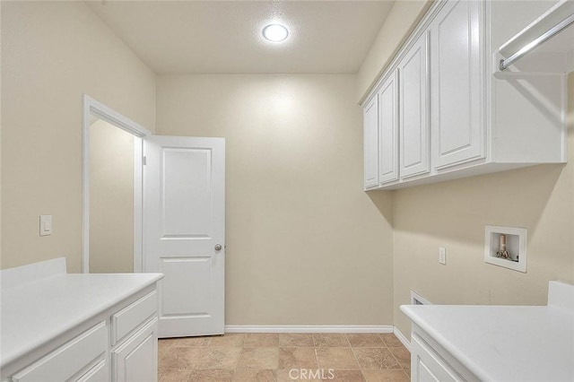 laundry room featuring hookup for a washing machine and cabinets