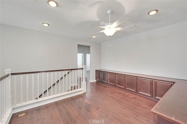 unfurnished room featuring ceiling fan and dark hardwood / wood-style floors