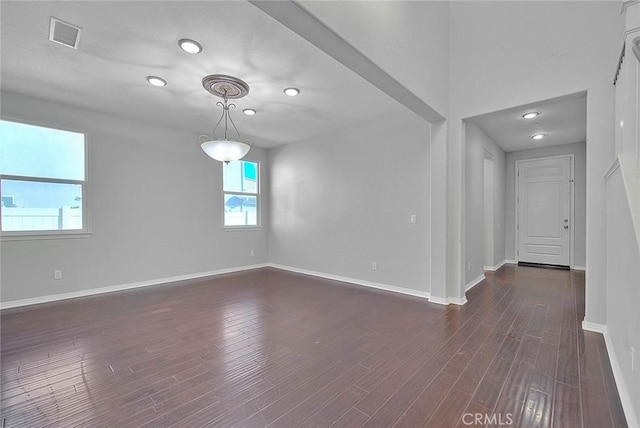 spare room featuring dark hardwood / wood-style floors