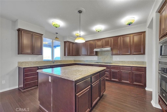 kitchen featuring a kitchen island, hanging light fixtures, dark hardwood / wood-style floors, and appliances with stainless steel finishes