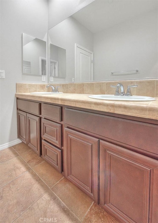 bathroom featuring tile patterned flooring and vanity