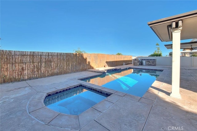 view of swimming pool with an in ground hot tub