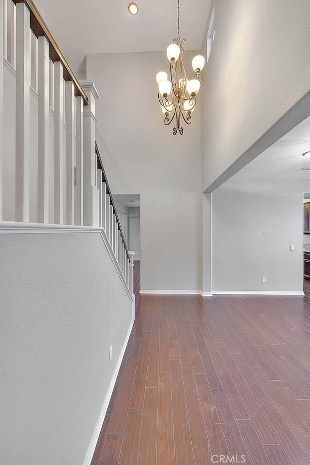 entrance foyer featuring a high ceiling, a chandelier, and dark hardwood / wood-style floors