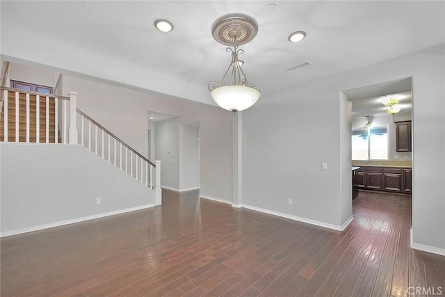 unfurnished living room with dark wood-type flooring