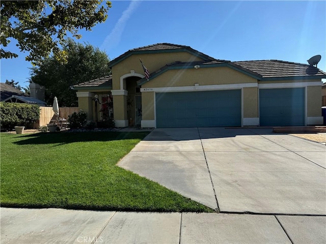 view of front of house with a garage and a front lawn