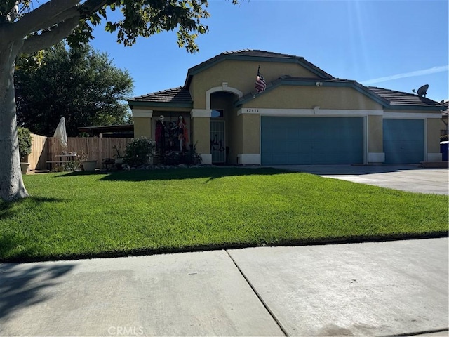 view of front of property with a front yard and a garage