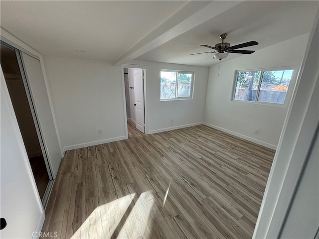 unfurnished bedroom with a closet, light wood-type flooring, and ceiling fan