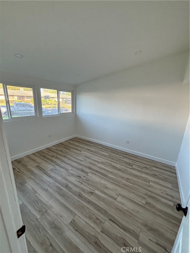 unfurnished room with light wood-type flooring