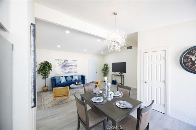 dining area featuring a chandelier and light hardwood / wood-style floors