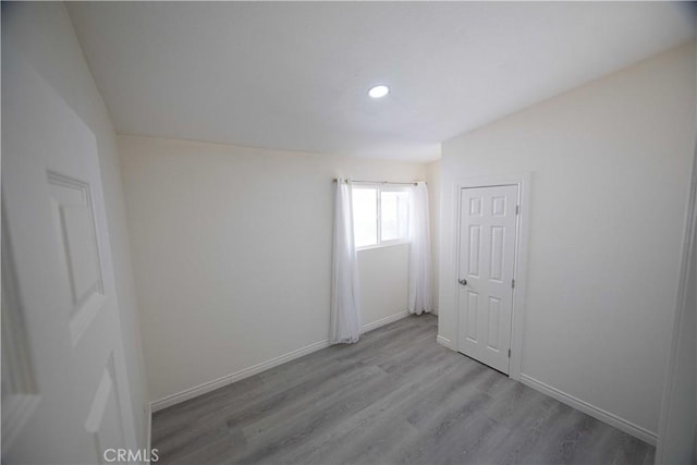 spare room featuring light hardwood / wood-style floors