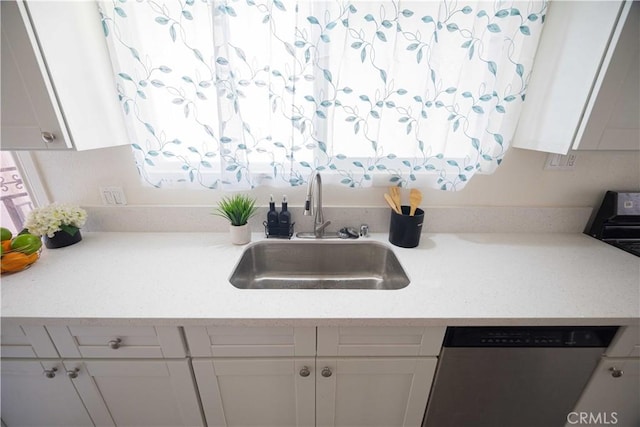 kitchen featuring white cabinetry, sink, and stainless steel dishwasher