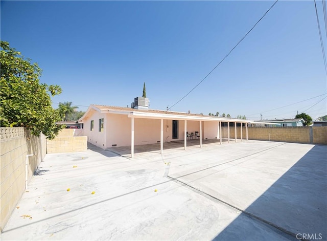 rear view of property featuring cooling unit and a patio area