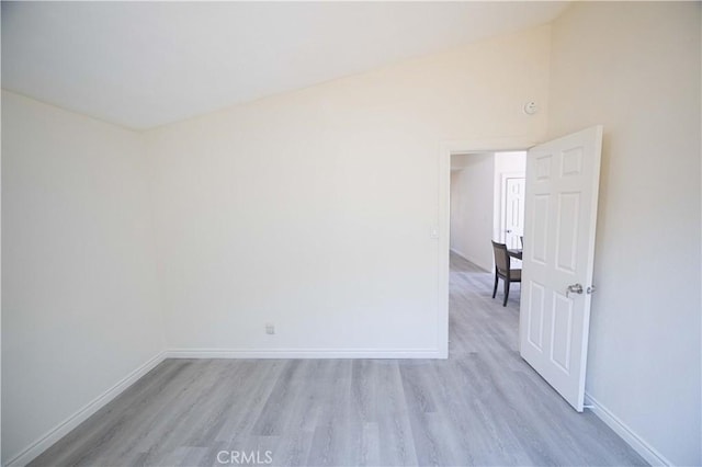 unfurnished room featuring high vaulted ceiling and light hardwood / wood-style flooring