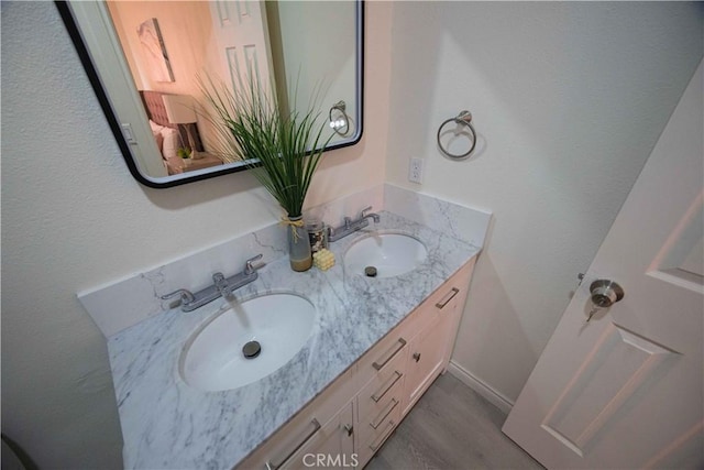 bathroom with hardwood / wood-style floors and vanity